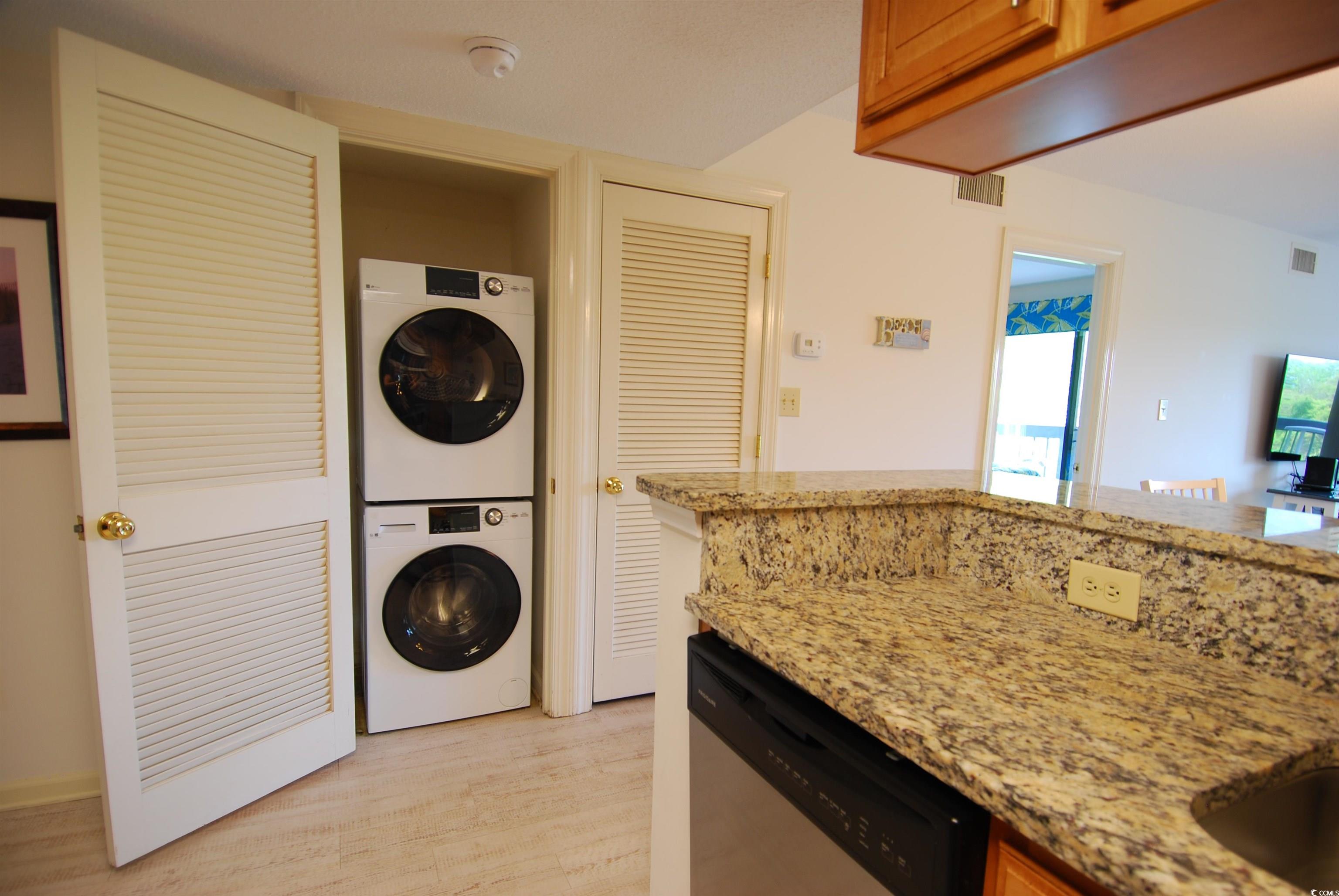 200 Lands End Boulevard, Unit 2015 Myrtle Beach, SC 29572 - Photo 12 of 28 Washroom featuring stacked washer and dryer and li