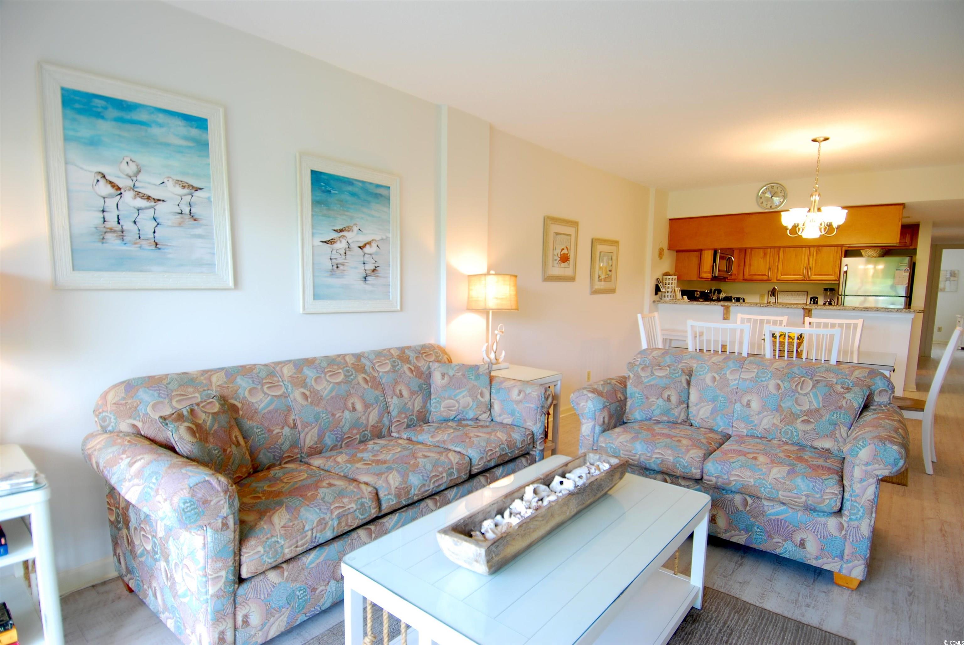 200 Lands End Boulevard, Unit 2015 Myrtle Beach, SC 29572 - Photo 2 of 28 Living room featuring a chandelier and light hardw