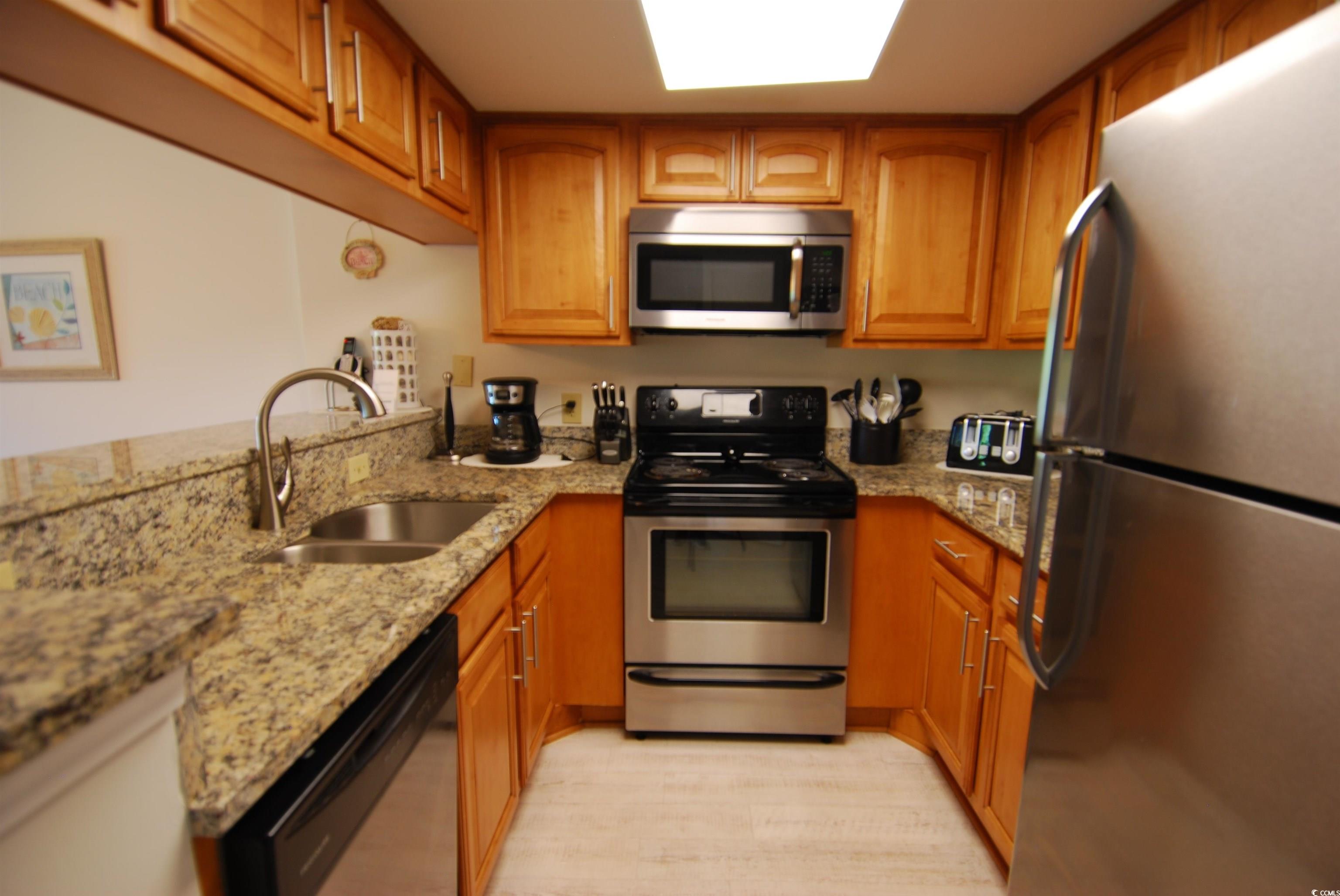 200 Lands End Boulevard, Unit 2015 Myrtle Beach, SC 29572 - Photo 9 of 28 Kitchen with stainless steel appliances, light sto