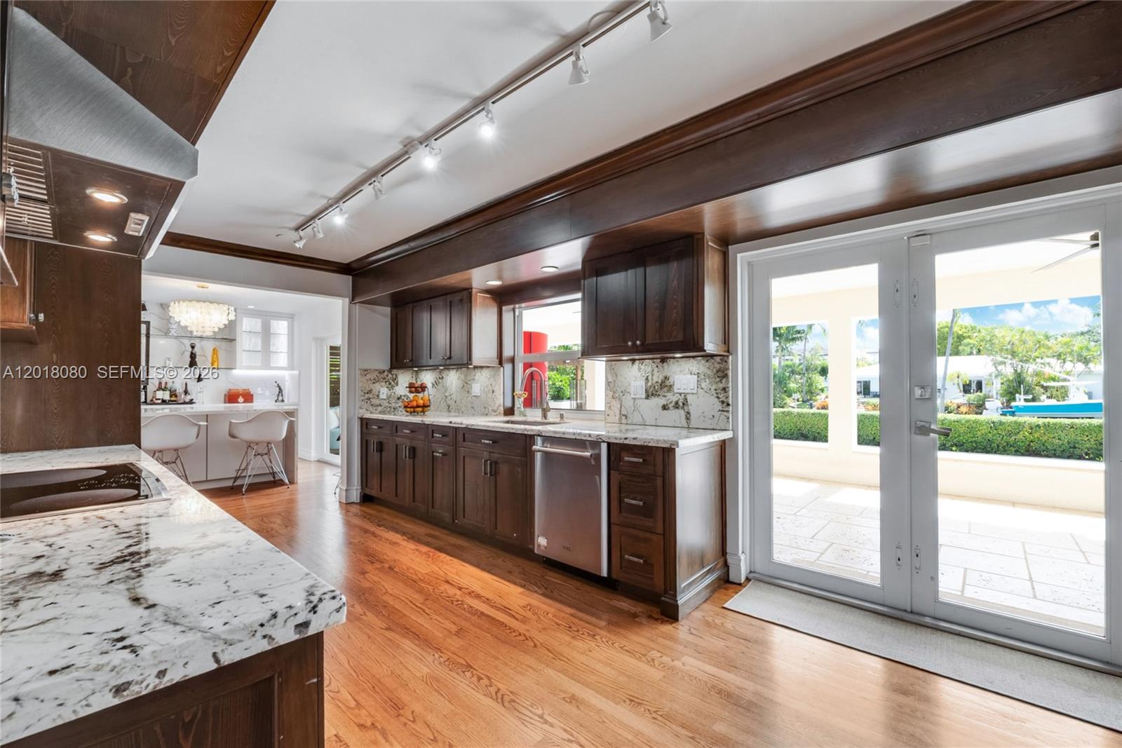 13035 Nevada Street Coral Gables, FL 33156 - Photo 9 of 21 a kitchen with stainless steel appliances granite countertop sink stove top oven and cabinets
