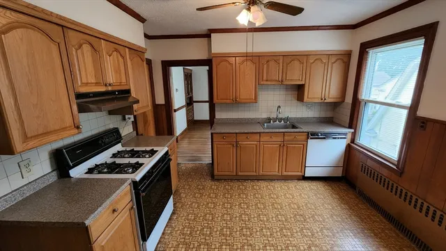 a kitchen with a stove a sink and a refrigerator