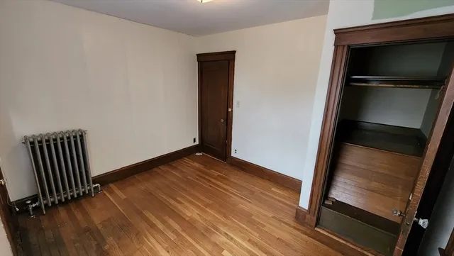 a view of an empty room and wooden floor
