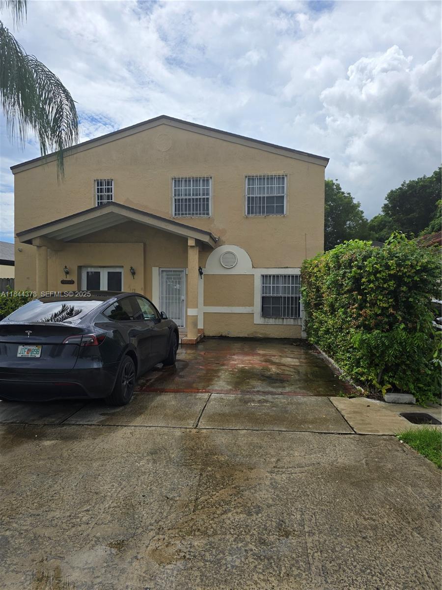 13748 Southwest 155th Terrace Miami, FL 33177 - Photo 1 of 12 a couple of cars parked in front of a house