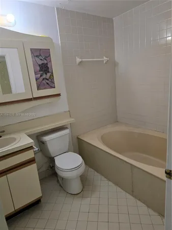 a bathroom with a toilet and a bathtub