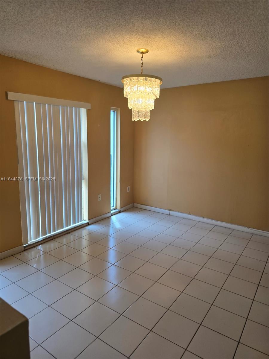 13748 Southwest 155th Terrace Miami, FL 33177 - Photo 3 of 12 an empty room with wooden floor