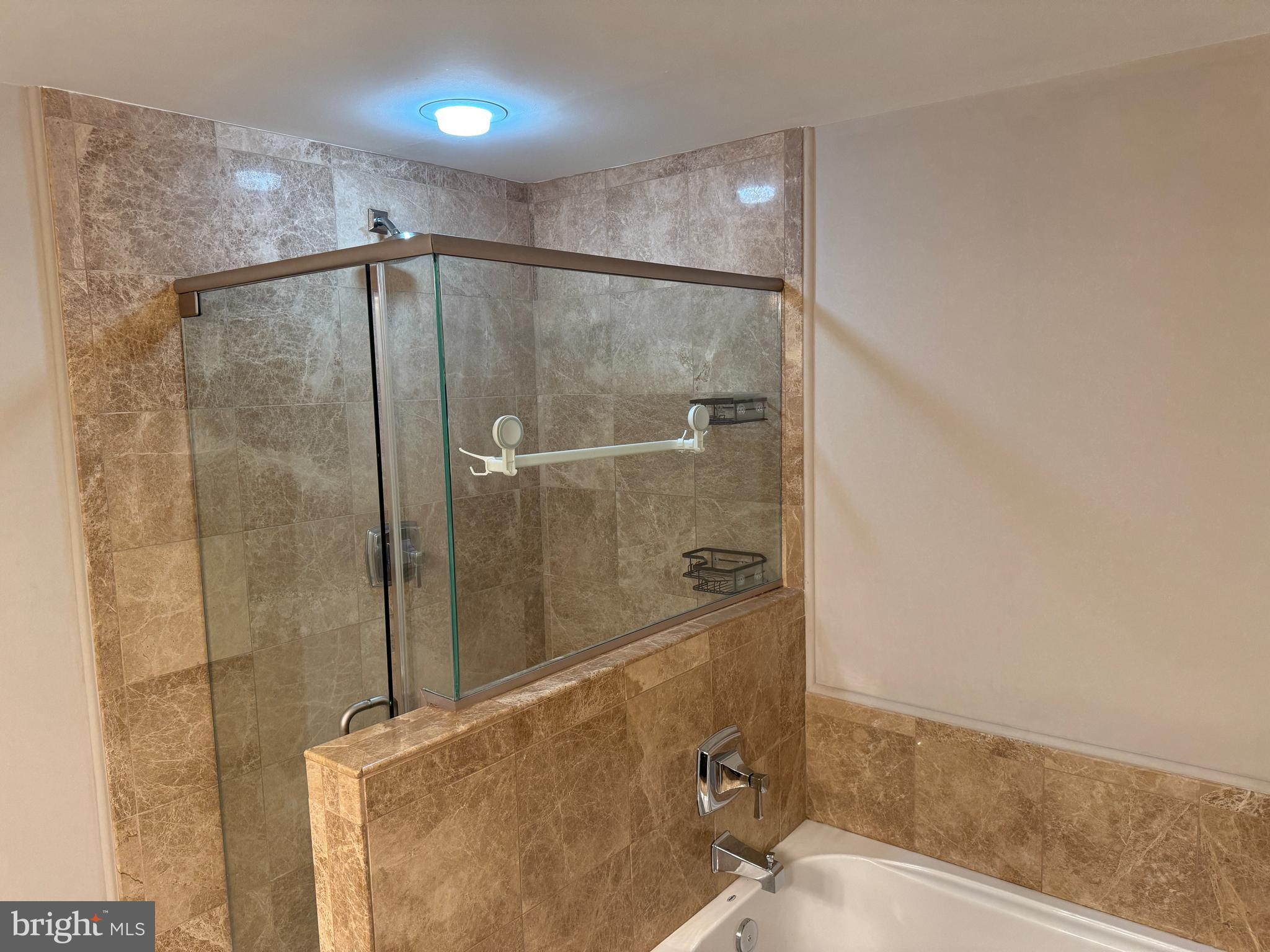 6301 Edsall Road, Unit 102 Alexandria, VA 22312 - Photo 12 of 24 a bathroom with a shower and a mirror