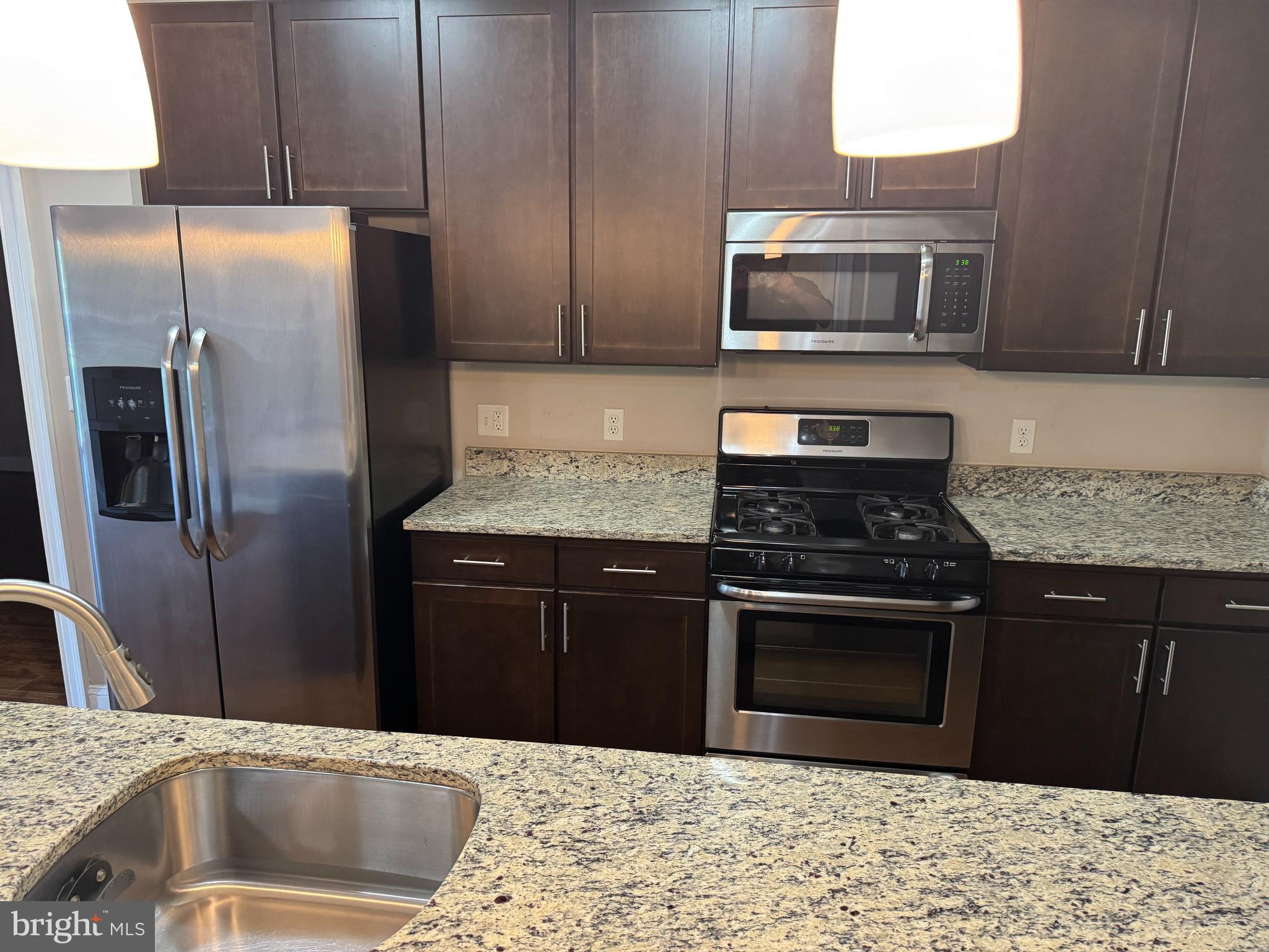 6301 Edsall Road, Unit 102 Alexandria, VA 22312 - Photo 5 of 24 a kitchen with a sink stove and refrigerator