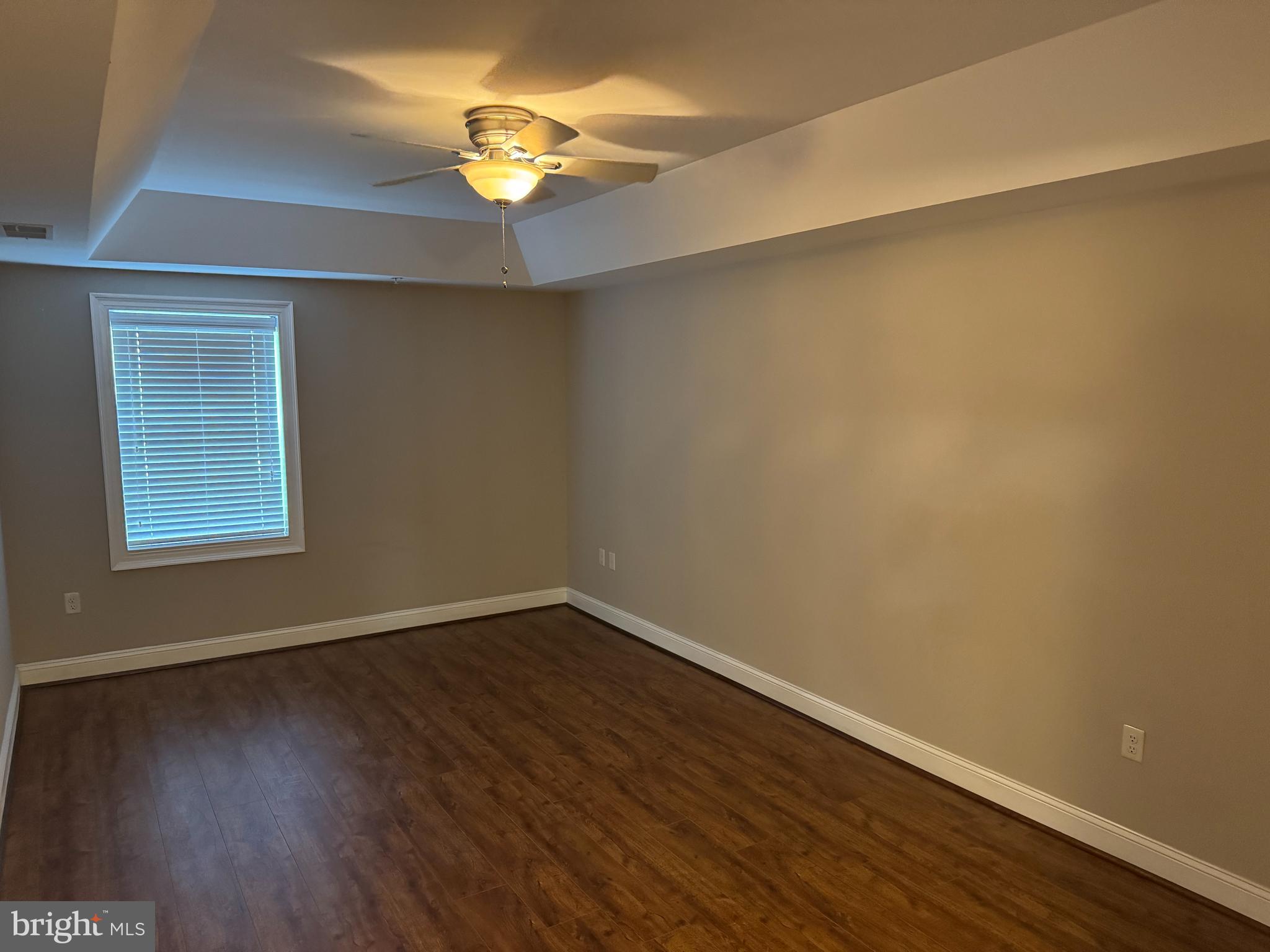 6301 Edsall Road, Unit 102 Alexandria, VA 22312 - Photo 9 of 24 a view of an empty room with wooden floor and a window