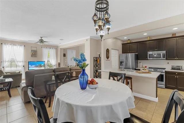 a large kitchen with a table and chairs