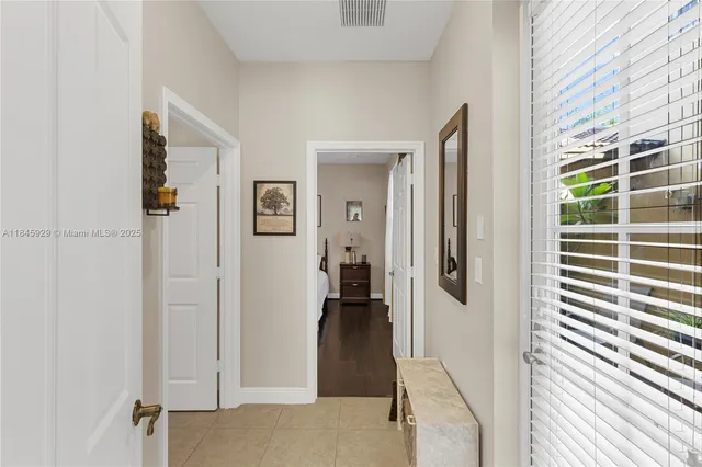 a view of a hallway with wooden floor and windows