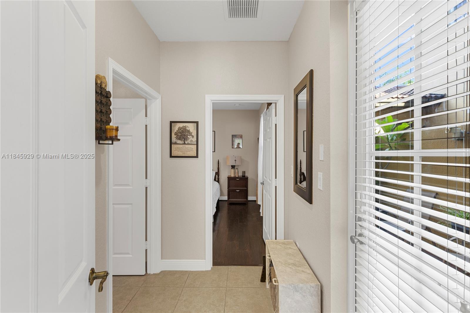 1112 Southwest 146th Terrace Pembroke Pines, FL 33027 - Photo 13 of 42 a view of a hallway with wooden floor and windows