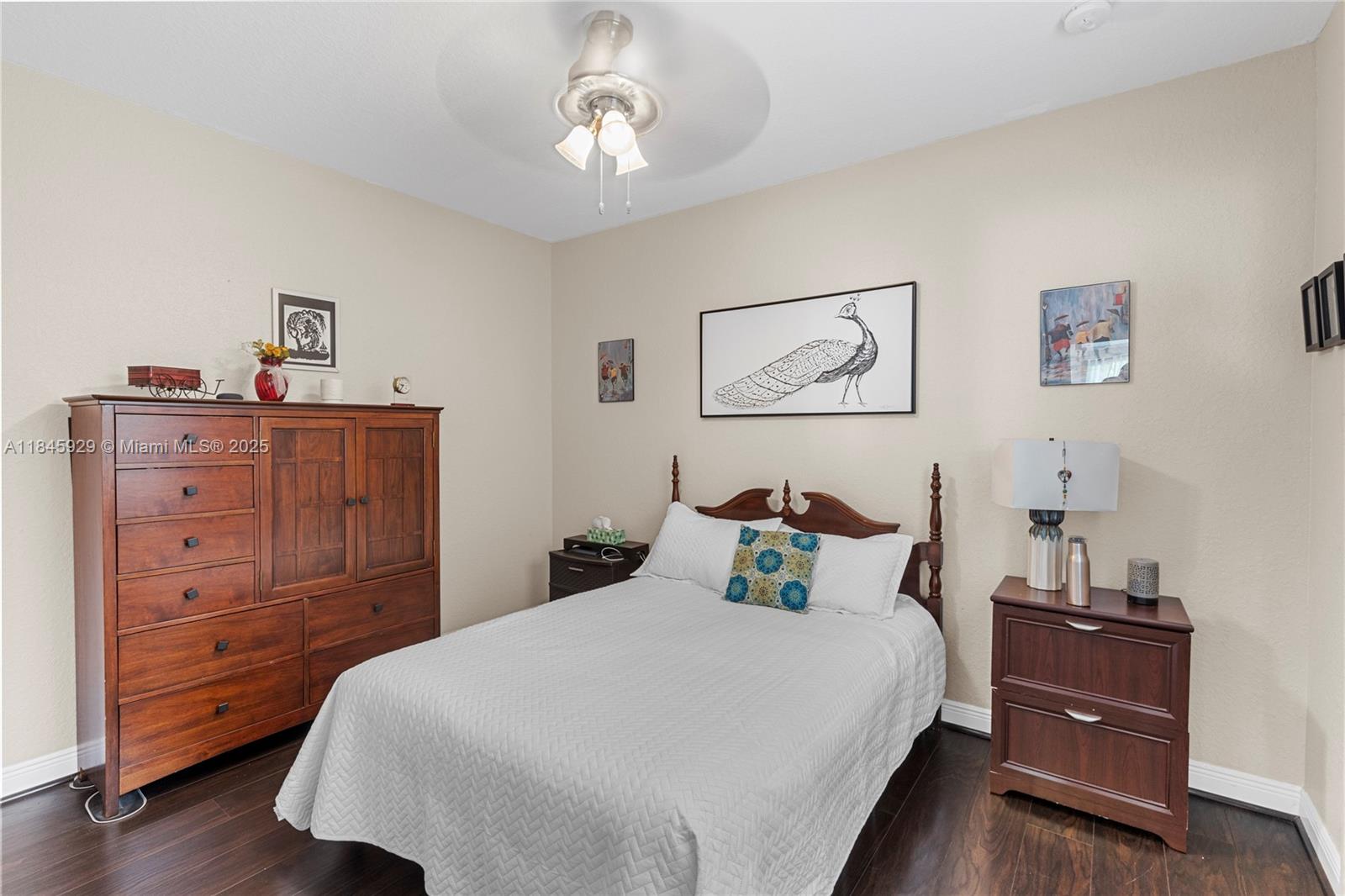 1112 Southwest 146th Terrace Pembroke Pines, FL 33027 - Photo 15 of 42 a bedroom with a bed and wooden floor