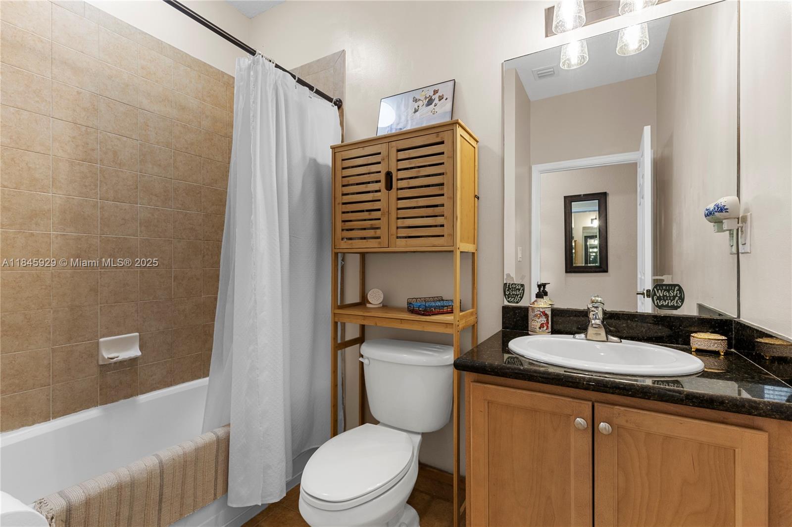 1112 Southwest 146th Terrace Pembroke Pines, FL 33027 - Photo 16 of 42 a bathroom with a granite countertop sink toilet and shower