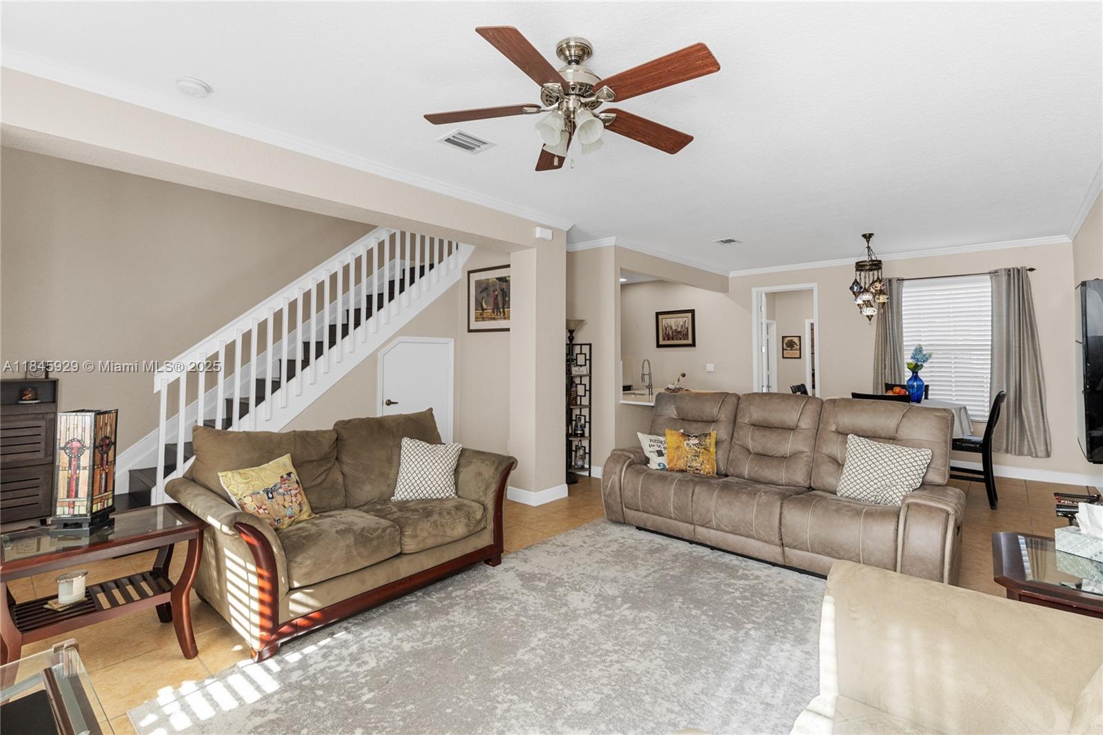 1112 Southwest 146th Terrace Pembroke Pines, FL 33027 - Photo 19 of 42 a living room with furniture and a dining table