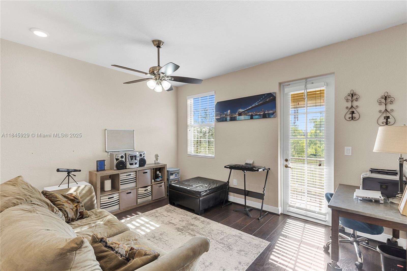 1112 Southwest 146th Terrace Pembroke Pines, FL 33027 - Photo 22 of 42 a living room with furniture and a window