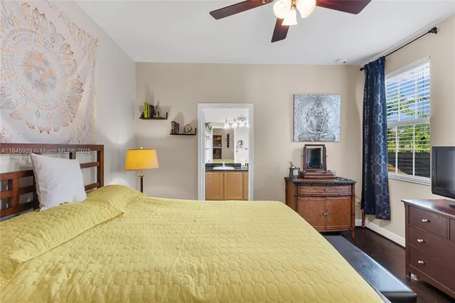 a bedroom with a bed and a lamp on dresser