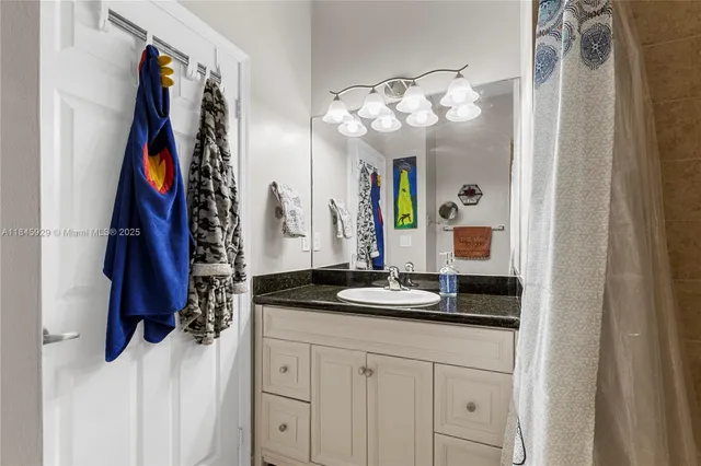 a bathroom with a sink vanity and a mirror