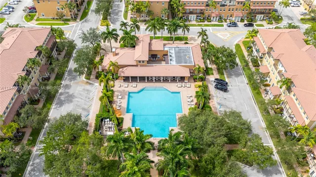 an aerial view of a house with outdoor space pool patio and lake view