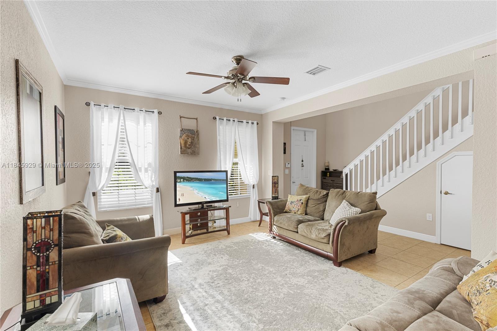 1112 Southwest 146th Terrace Pembroke Pines, FL 33027 - Photo 6 of 42 a living room with furniture or couch and a chandelier