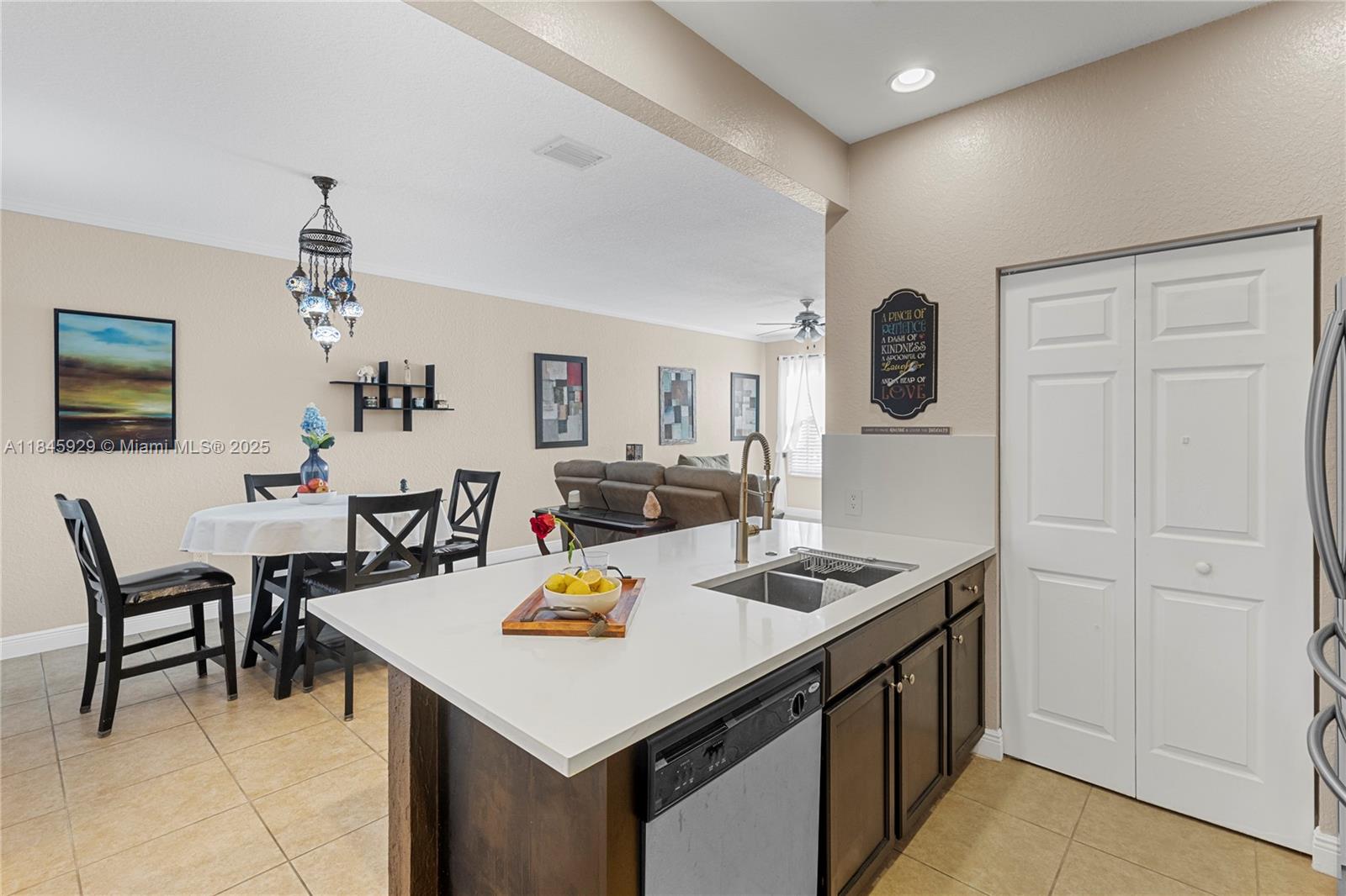 1112 Southwest 146th Terrace Pembroke Pines, FL 33027 - Photo 10 of 42 a view of a dining room with furniture and chandelier