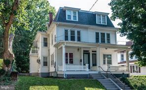 Charming multi-story home with inviting porch.
