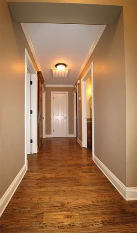 a view of a hallway with wooden floor