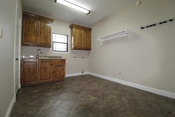 a view of a kitchen with a sink cabinets and a window