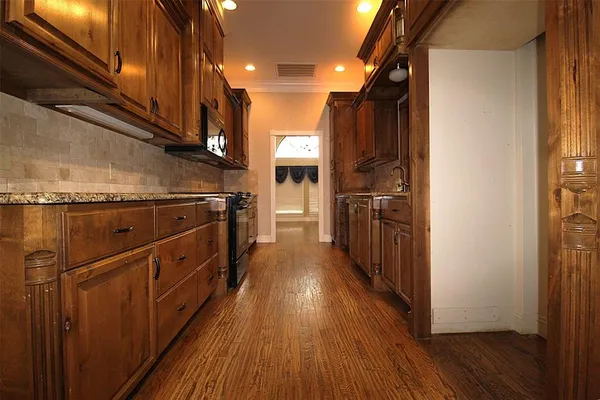 a kitchen with wooden floors and a kitchen view