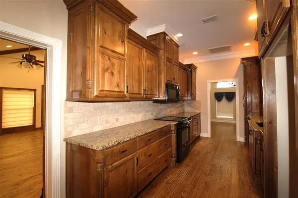 a kitchen with stainless steel appliances granite countertop a stove and a refrigerator