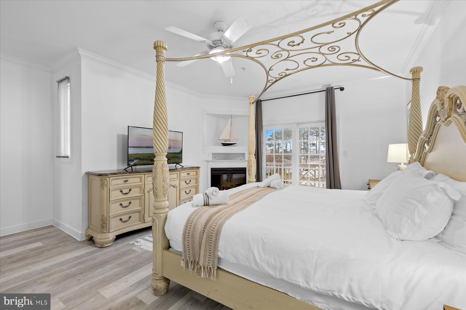 9823 Golf Course Road, Unit 10 Ocean City, MD 21842 - Photo 11 of 40 a bedroom with a large bed and a window