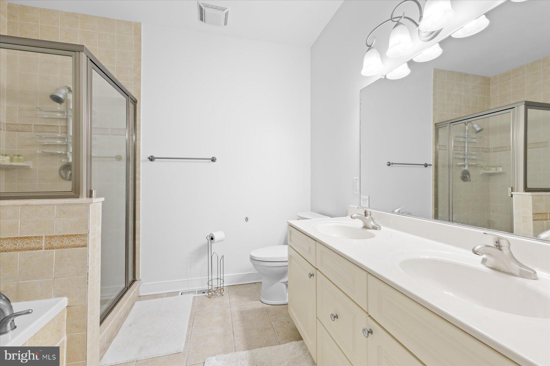 9823 Golf Course Road, Unit 10 Ocean City, MD 21842 - Photo 14 of 40 a bathroom with a double vanity sink mirror and toilet