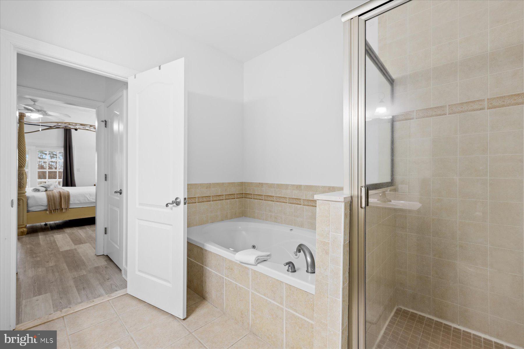 9823 Golf Course Road, Unit 10 Ocean City, MD 21842 - Photo 15 of 40 a bathroom with a tub and shower