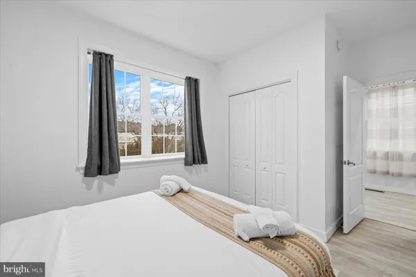 a bedroom with a bed and a large window