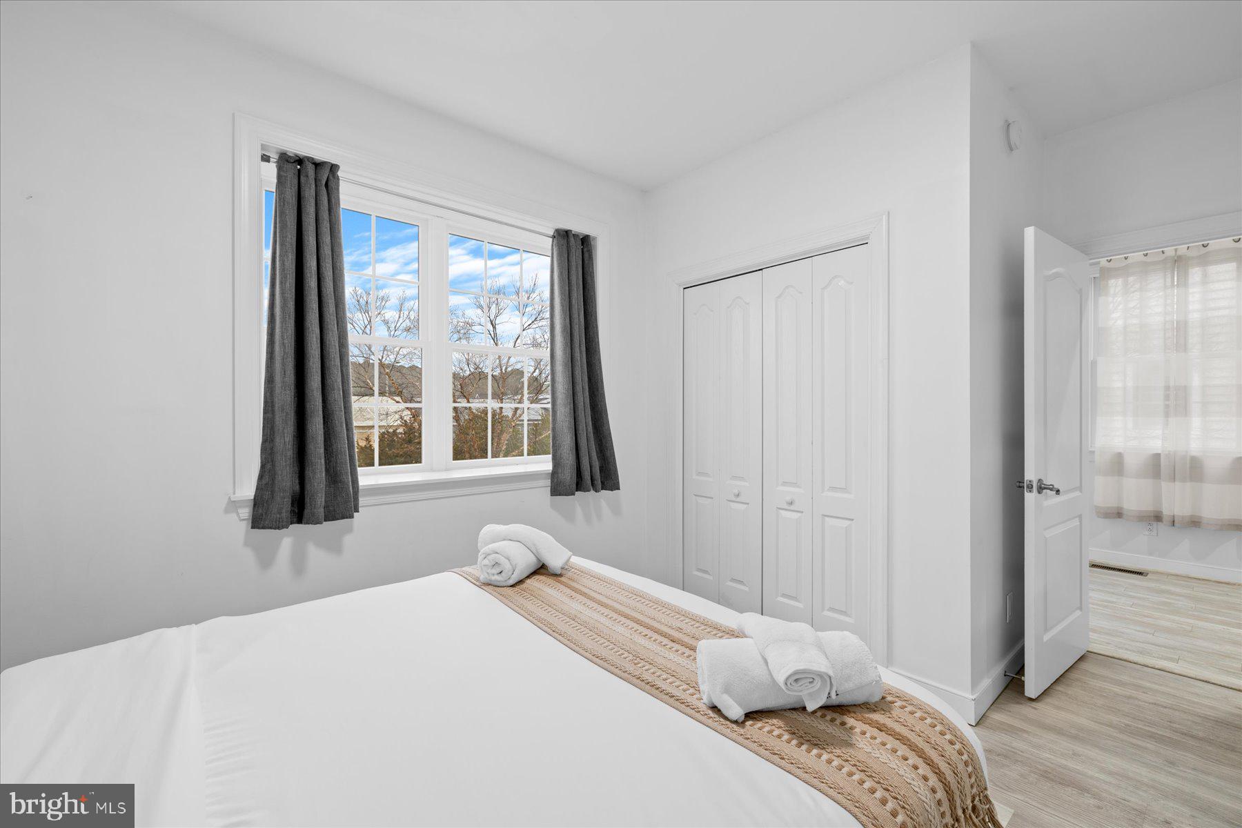 9823 Golf Course Road, Unit 10 Ocean City, MD 21842 - Photo 20 of 40 a bedroom with a bed and a large window