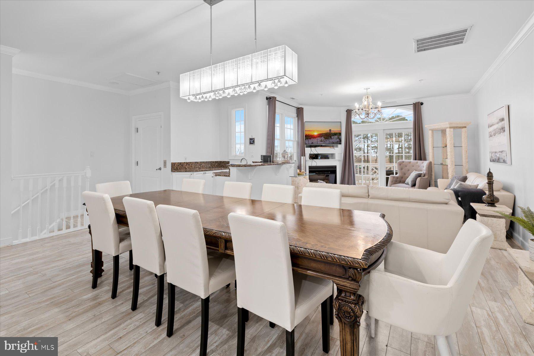 9823 Golf Course Road, Unit 10 Ocean City, MD 21842 - Photo 26 of 40 a view of a dining room with furniture and wooden floor