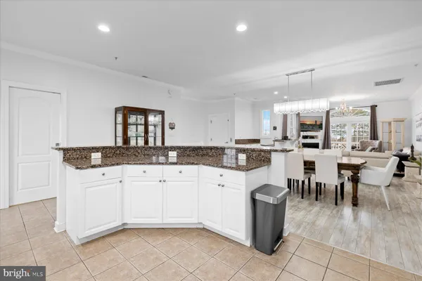 a kitchen with cabinets and chairs