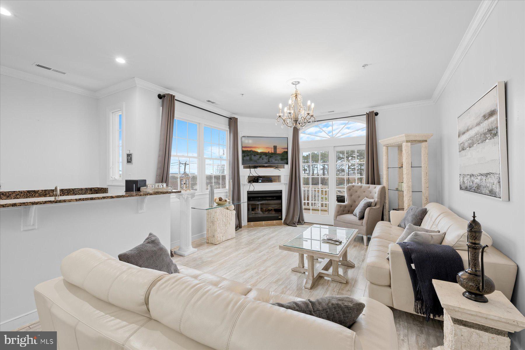 9823 Golf Course Road, Unit 10 Ocean City, MD 21842 - Photo 33 of 40 a living room with furniture kitchen view and a large window