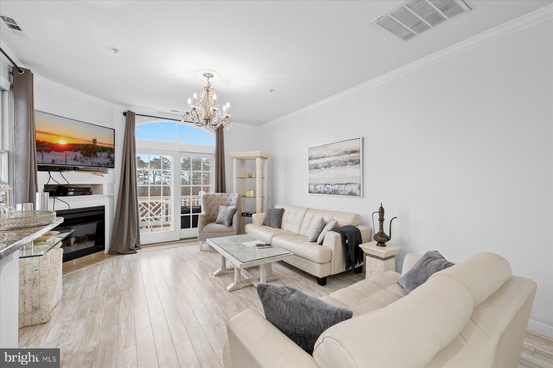 9823 Golf Course Road, Unit 10 Ocean City, MD 21842 - Photo 34 of 40 a living room with furniture large window and wooden floor