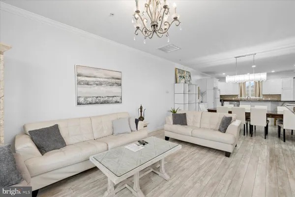 a living room with furniture and a chandelier