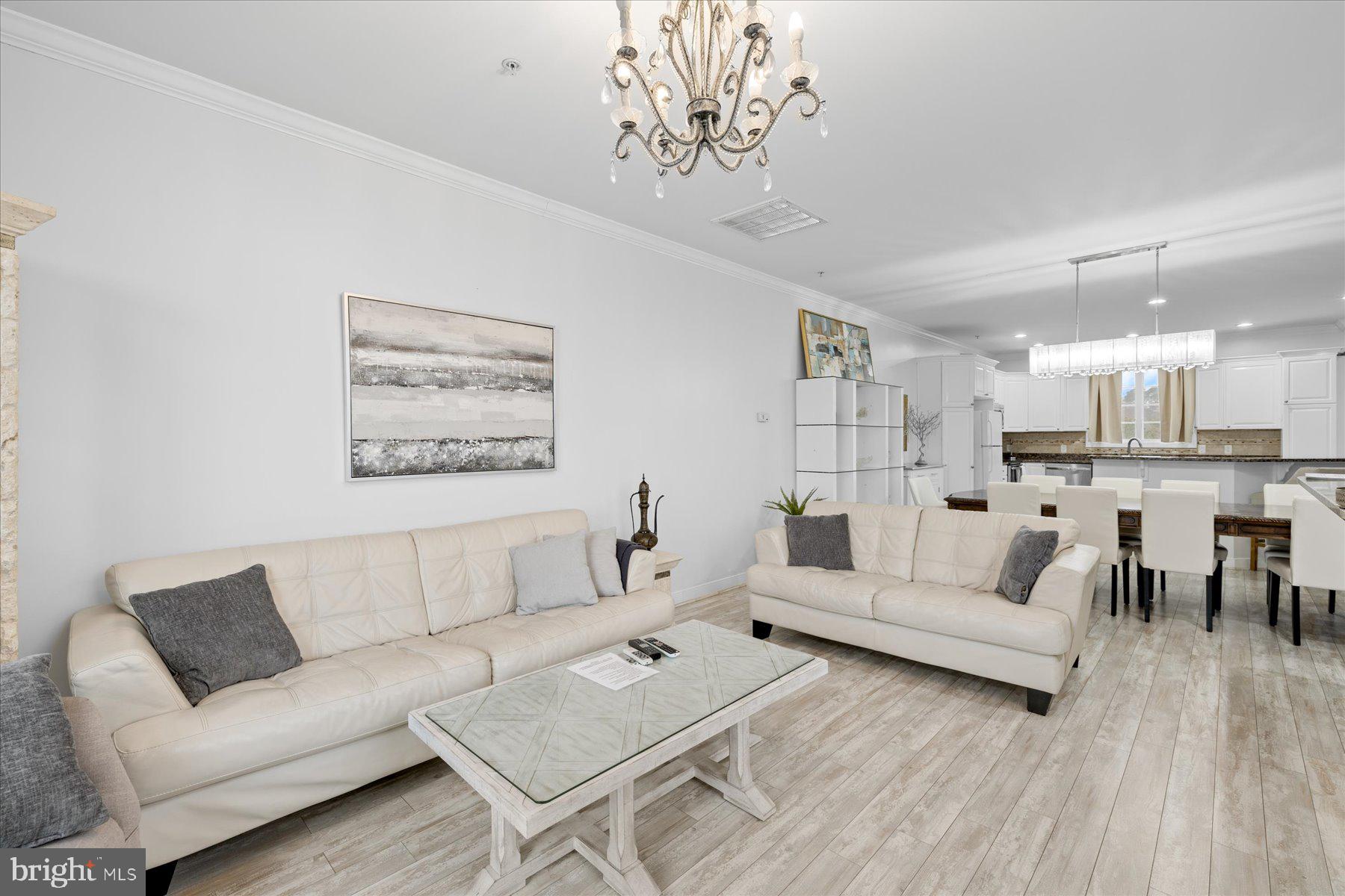 9823 Golf Course Road, Unit 10 Ocean City, MD 21842 - Photo 36 of 40 a living room with furniture and a chandelier
