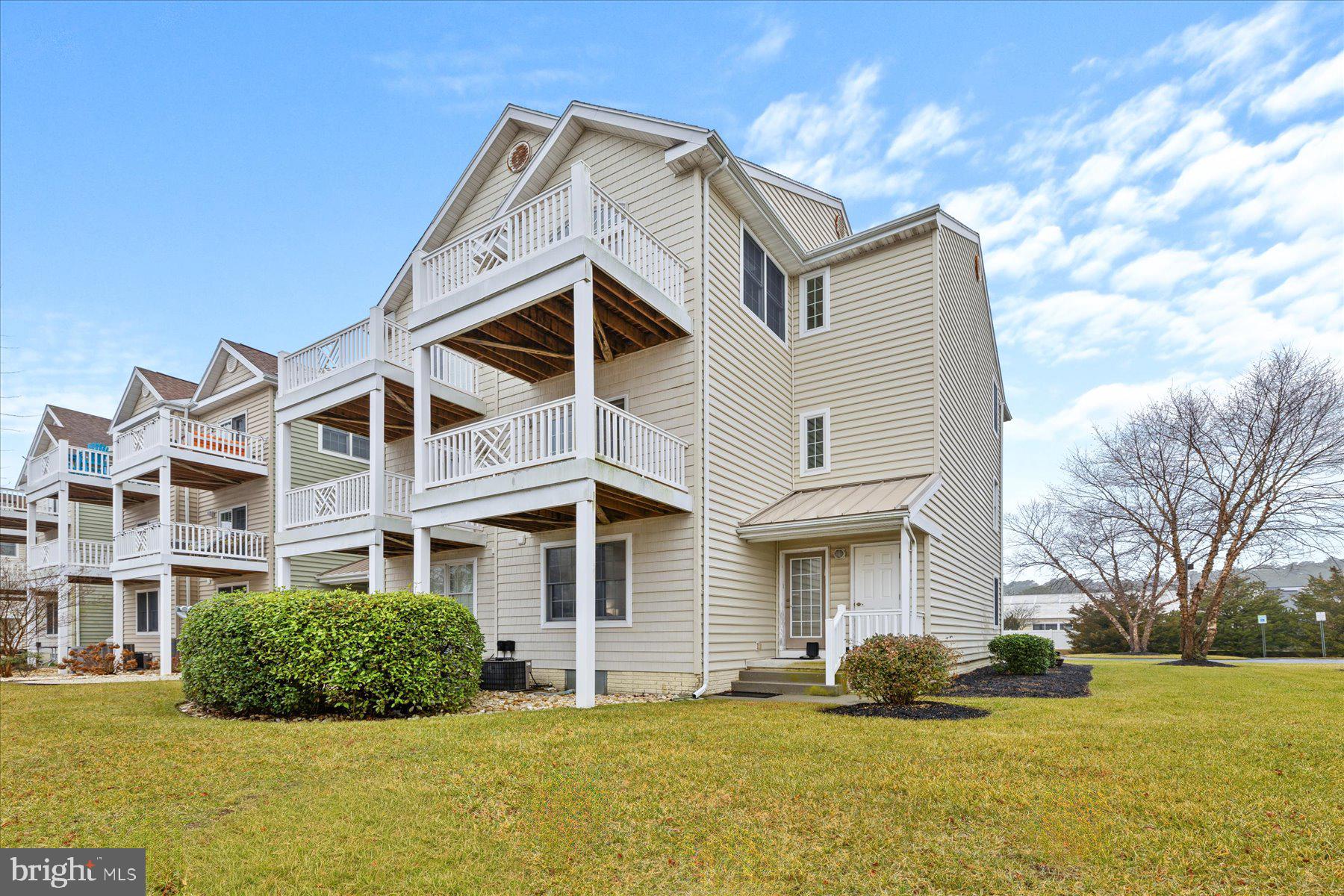 9823 Golf Course Road, Unit 10 Ocean City, MD 21842 - Photo 38 of 40 a front view of a house with a yard