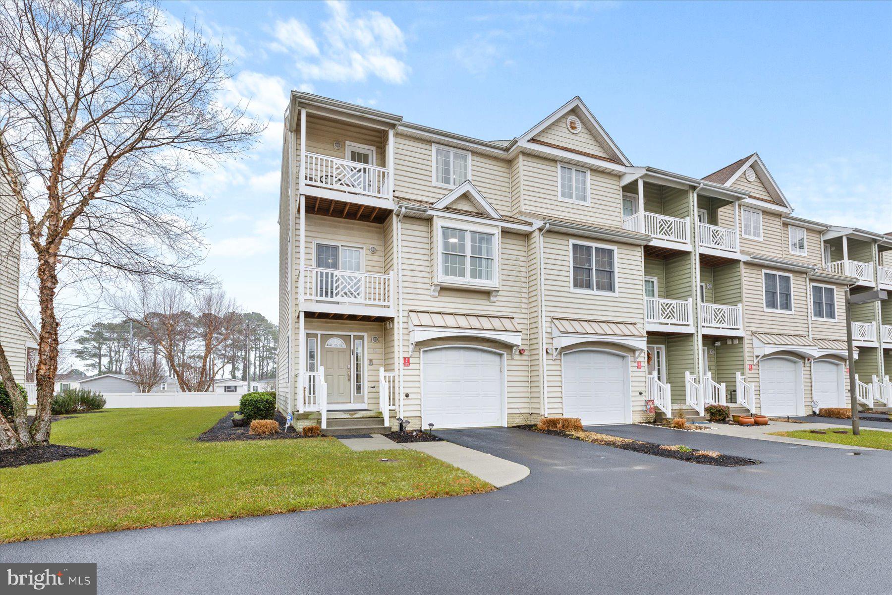 9823 Golf Course Road, Unit 10 Ocean City, MD 21842 - Photo 39 of 40 a front view of house with yard and green space