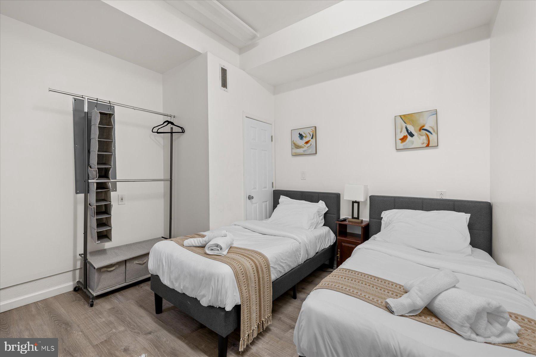 9823 Golf Course Road, Unit 10 Ocean City, MD 21842 - Photo 4 of 40 a bedroom with two beds and a wall painting