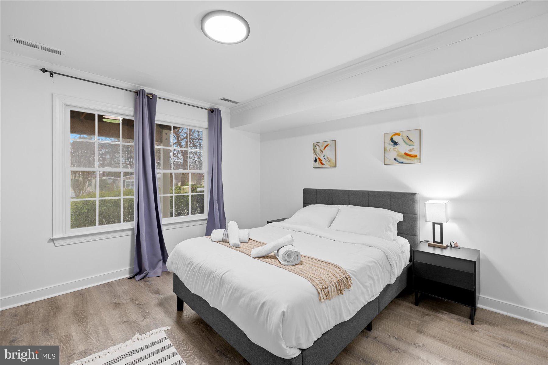 9823 Golf Course Road, Unit 10 Ocean City, MD 21842 - Photo 6 of 40 a bedroom with a bed and a window