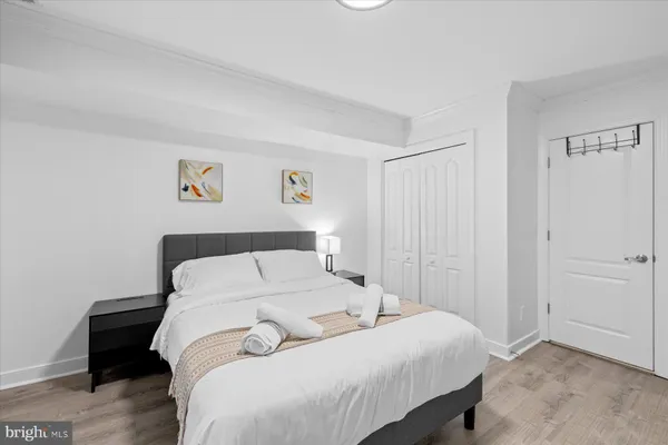 a bedroom with a bed and painting on the wall