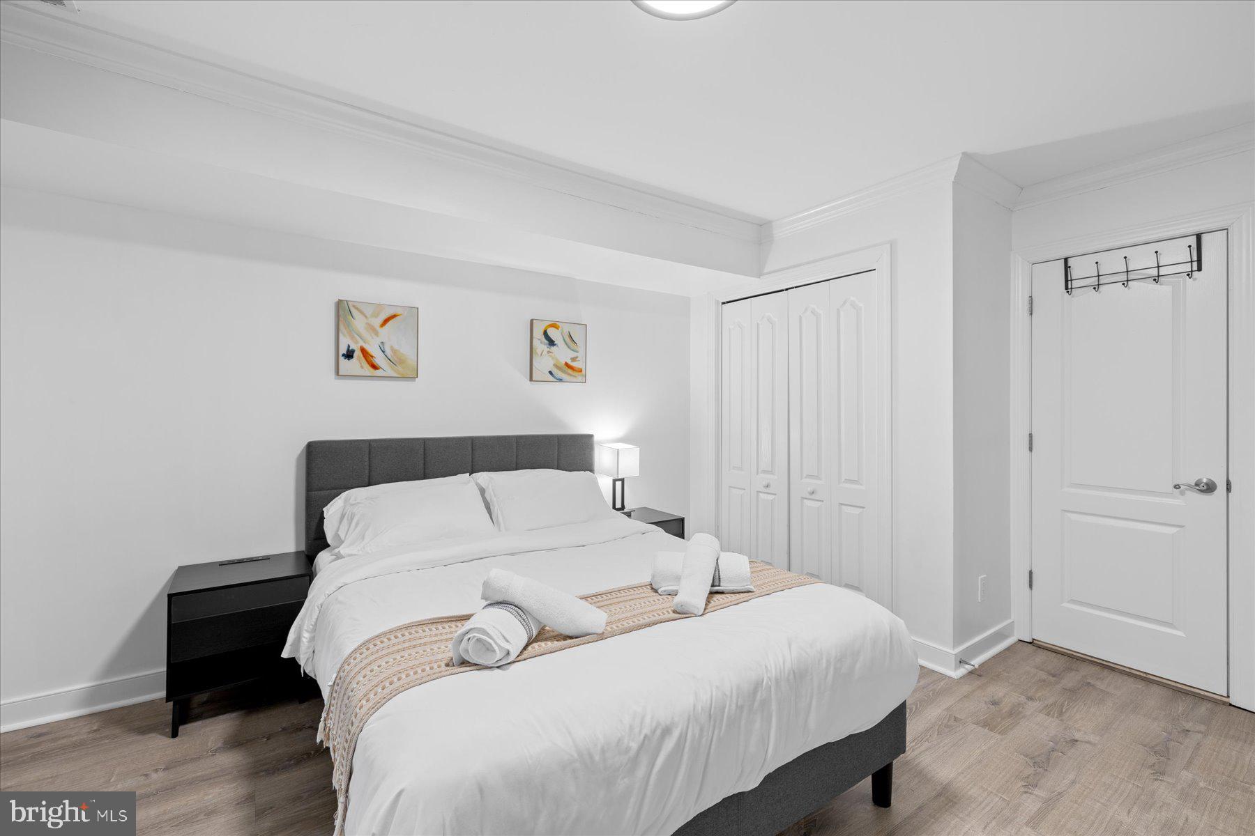 9823 Golf Course Road, Unit 10 Ocean City, MD 21842 - Photo 8 of 40 a bedroom with a bed and painting on the wall