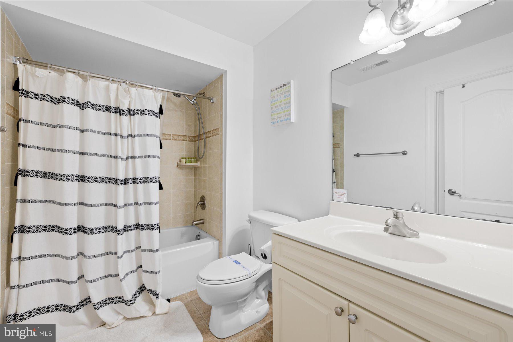 9823 Golf Course Road, Unit 10 Ocean City, MD 21842 - Photo 9 of 40 a bathroom with a sink toilet and shower