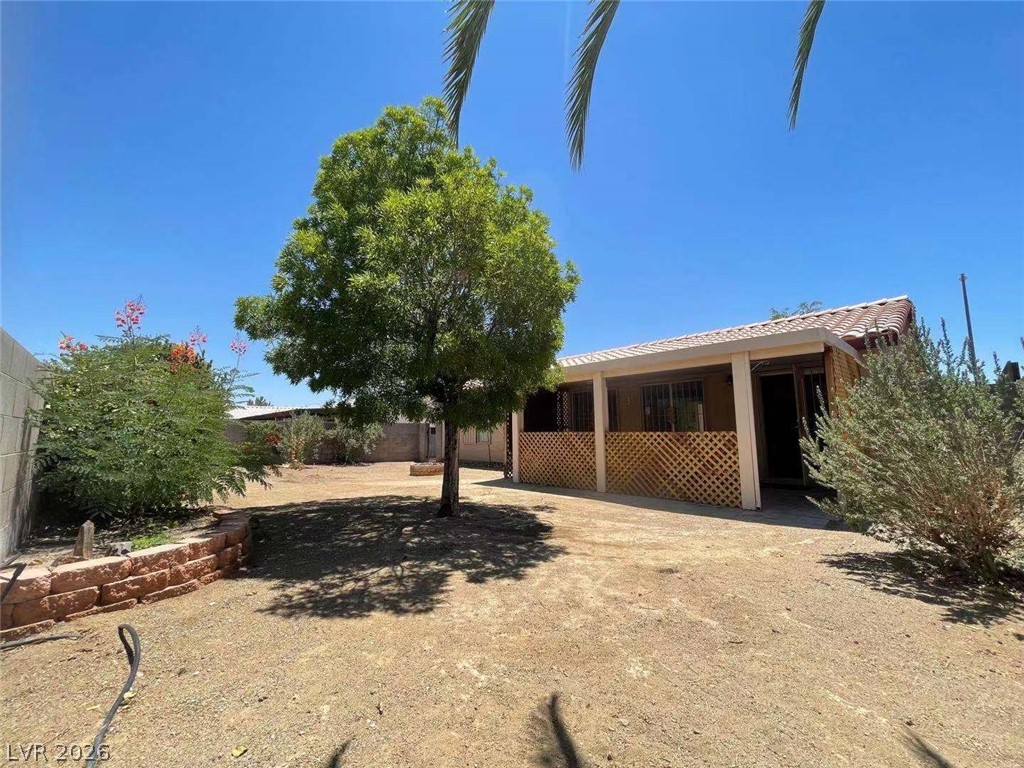 3500 Redwood Ridge Way North Las Vegas, NV 89031 - Photo 13 of 13 An inviting covered patio offers a shaded retreat overlooking the backyard, perfect for outdoor relaxation.