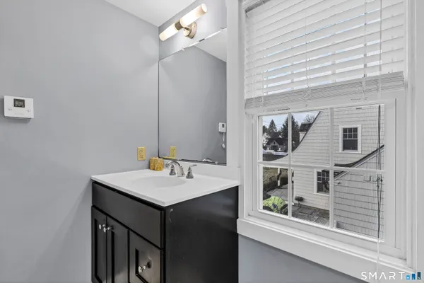 a bathroom with a sink vanity and mirror