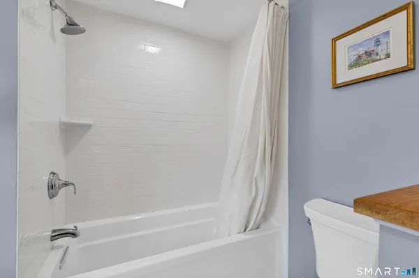 a bathroom with a shower and a toilet